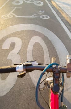Cyclist riding y priority lane for bikes and electric kick scooters. POV shot