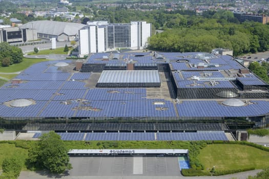 Brussels, Belgium, May 2023: View on the rooftop solar panels and Trademart Building at Brussels Expo on Heysel Plateau in Belgium.