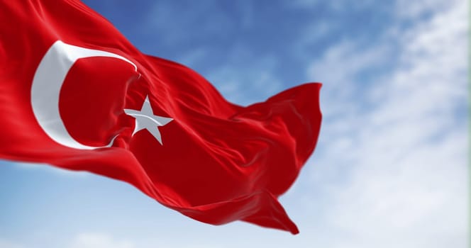 Turkish national flag waving in the wind on a clear day. Red flag with white crescent and a star. 3D illustration render. Fluttering fabric. Selective focus