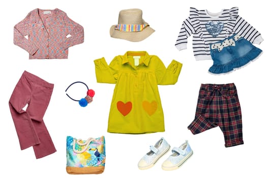 Collage set of little girl summer clothes isolated on white. Kids apparel collection. Childs fashion clothing outfit. Jeans skirt, shorts, shirt, dresses, pants, bag, shoes.