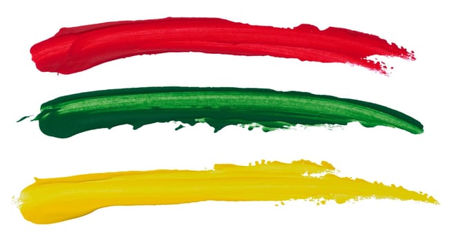 Strokes of red, green and yellow acrylic paint on a white isolated background