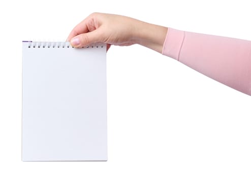 Female hand holding a notepad with blank white sheets on a white isolated background
