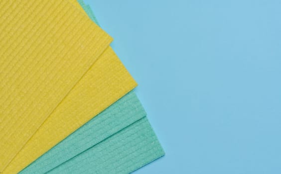 Square sponges for the kitchen and home on a blue background