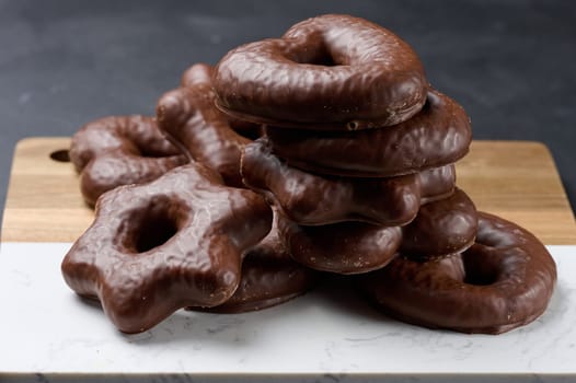 Chocolate gingerbread cookies on black table, top view