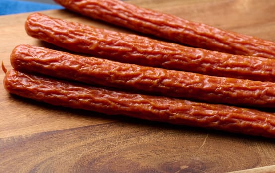 Traditional Polish thin smoked sausages on a black background