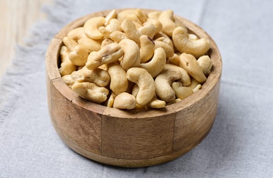 Cashews in a wooden bowl on the table