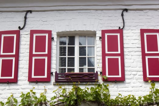 Old German house with windows with wooden shutters, Wachtendonk, North-Rhine Westphalia, Germany