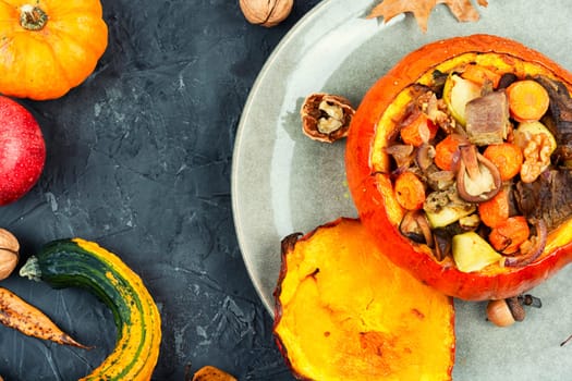 Baked pumpkin stuffed with beef meat, mushrooms, apple and carrots. Halloween food