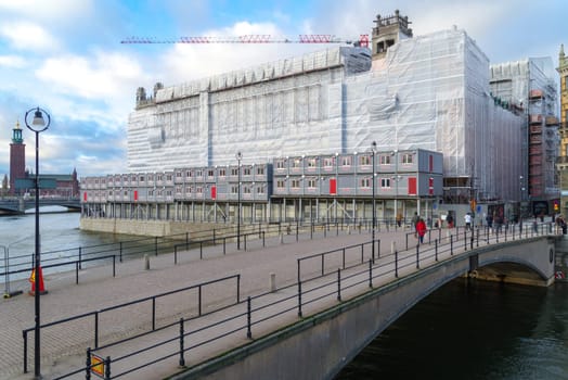 STOCKHOLM, SWEDEN- DECEMBER 23, 2020: Large building under construction with the State bridge (Riksbron) in front.