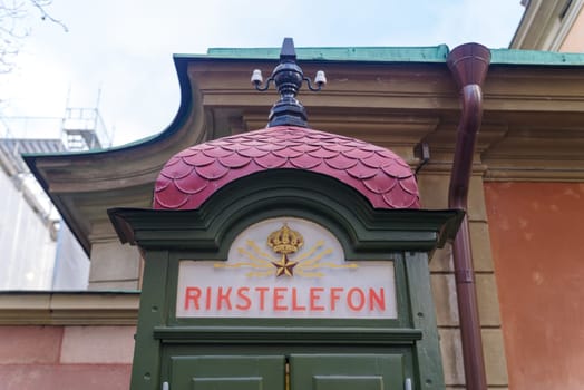 old public telephone booth (rikstelefon) in the old city center (gamla stan) of stockholm