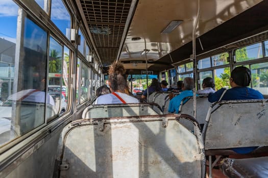 Nadi, Fiji - 23 May 2023: Indigenous Fijian people travel by bus. In Fiji every town and village has a bus stop since this is still the most common form of transportation in the islands.
