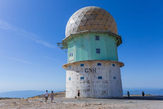 Serra da Estrela, Portugal: 22 August 2023: People in Torre and transmitting towers with golden cupola, the highest point of Portugal, in Serra da Estrela
