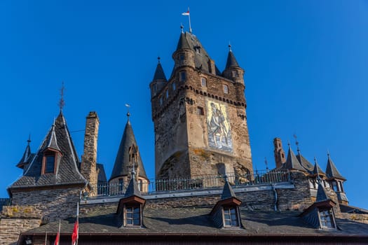 Cochem, Germany, August 10, 2023. Beautiful view of the hilltop castle (Reichsburg Cochem) in the touristic town of Cochem on the Moselle River in Rhineland-Palatinate in Germany.