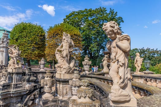 Dresden, Germany - August 10.2023: People among the Fariy figures and statues on the Nymphenbad at baroque Zwinger palace.