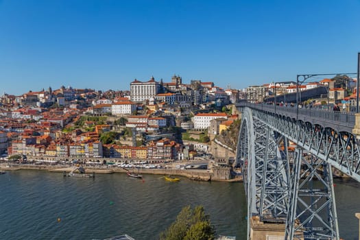 Porto, Portugal - March 02, 2023: View of Ribeira historical quarter on the margin Douro river embankment in the old town and Luis I bridge, Porto, Portugal.