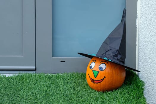 Laughing halloween pumpkin with black hat