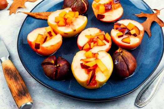 Tasty baked autumn apples and figs, fruit dessert. Fall dish