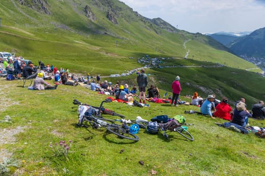 Col du Tourmalet, France - July 06 2023: Cycling fans waiting for the buch at the top of the Col du Tourmalet in Pyerenees mountains during the stage 6 of Le Tour de France 2023