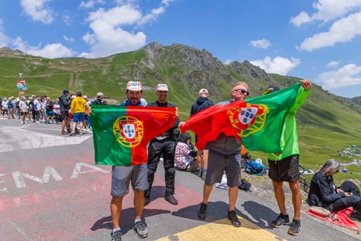Col du Tourmalet, France - July 06 2023: Cycling fans waiting for the buch at the top of the Col du Tourmalet in Pyerenees mountains during the stage 6 of Le Tour de France 2023