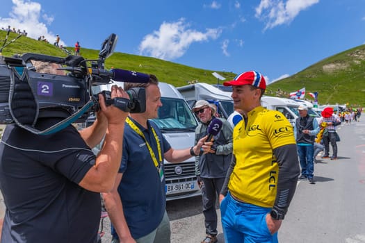 Col du Tourmalet, France - July 06 2023: Cycling fans waiting for the buch at the top of the Col du Tourmalet in Pyerenees mountains during the stage 6 of Le Tour de France 2023