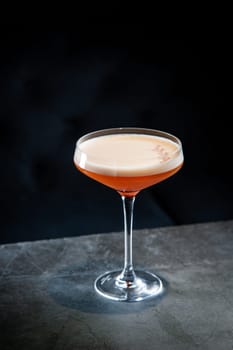 tropical cocktail with foam in a martini glass