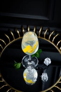 transparent carbonated cocktail with lemon and ice
