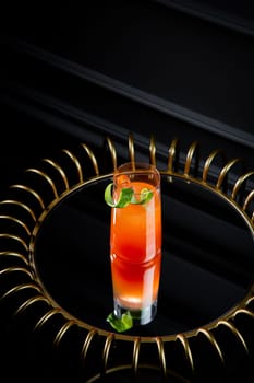 tropical cocktail with sunset gradient and citrus