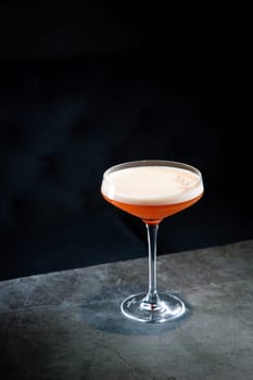 tropical cocktail with foam in a martini glass