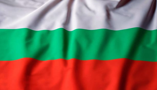 Bulgaria flag with big folds waving close up under the studio light indoors. The official symbols and colors in fabric banner