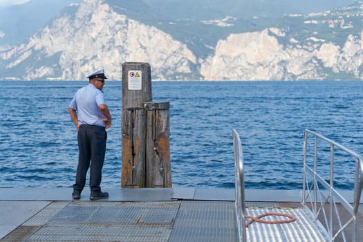 An employee of the Garda Express transport company waits for the ferry for tourists from Limone Sul Garda to Malcesine