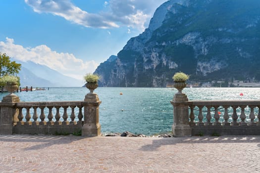 Waterfront promenade with a view of Lake Garda in the popular resort of Riva del Garda in Italy