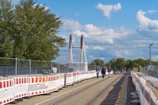 Construction site of the new Kaiser-Otto-Bridge in Magdeburg with some walkers. The new construction of the bridge is currently the largest and most expensive construction project in the city.