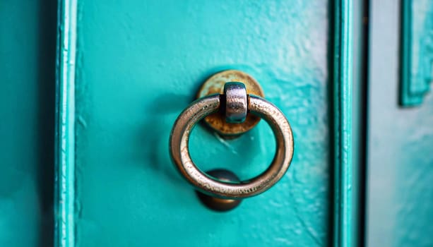 blue turquoise vintage wooden door with golden frame and old black metal door holders close up shot as showing wooden texture
