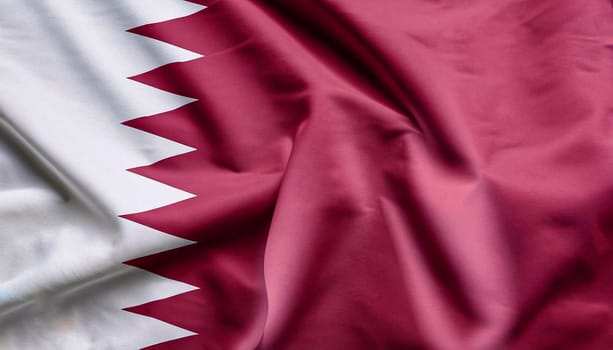 Fabric texture flag of Qatar. flag of qatar with folds with visible satin texture