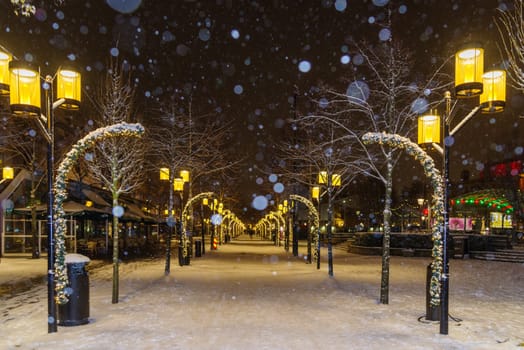 street filled with christmas lights in a dark stockholm