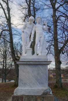 two white statues in Drottningholms palace park in stockholm