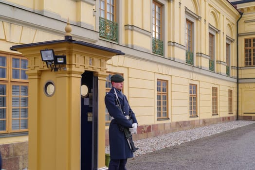STOCKHOLM, SWEDEN- DECEMBER 24, 2020: Palace guard standing in front of Drottningholm palace just outside Stockholm.