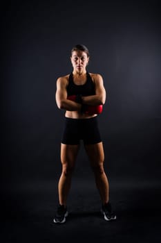 Young woman athletic female MMA fighter is training. Concept of sport, action, healthy lifestyle.