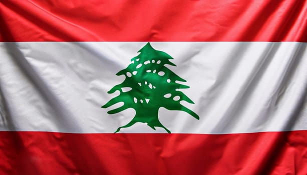 Lebanon flag with big folds waving close up under the studio light indoors. The official symbols and colors in fabric banner