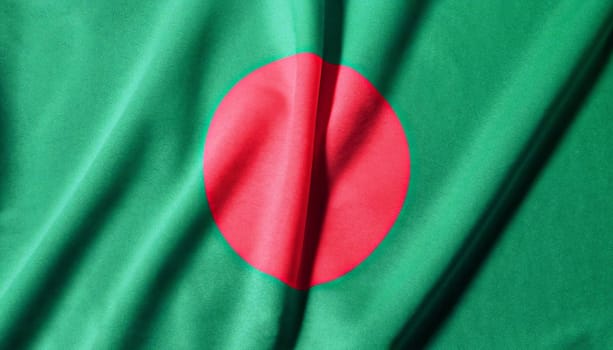 Bangladesh flag with big folds waving close up under the studio light indoors. The official symbols and colors in fabric banner