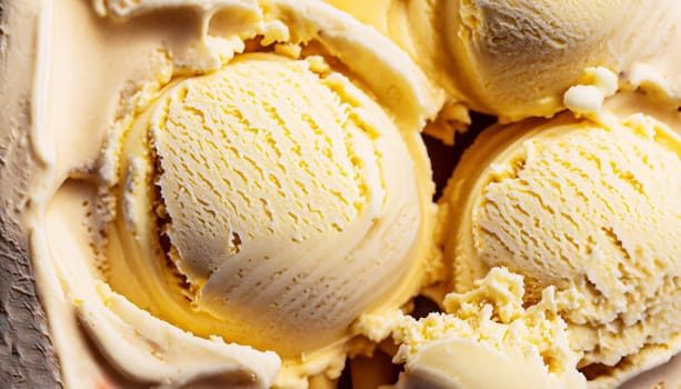 Scoop of yellow ice cream with banana flavour, viewed in close-up on grey background