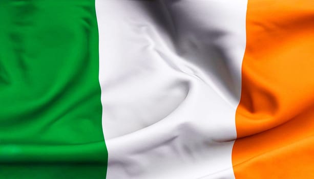 Ireland flag with big folds waving close up under the studio light indoors. The official symbols and colors in fabric banner