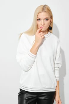 Distrustful or doubting woman biting her lip on white background