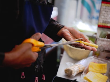 yellow egg wonton is on  women hand