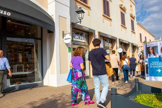 AGIRA, SICILY, Italy - 30 SEP 2023. Sicilia Outlet Village shopping centre is a popular visitor magnet. People shopping at Sicilia Outlet Village.
