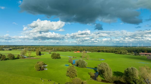 aerial view of a beautiful green landscape with a small river flowing through. It is in the eastern part of the Netherlands