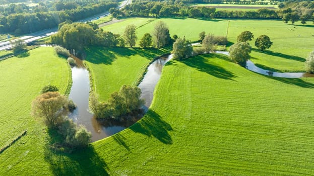 aerial view of a beautiful green landscape with a small river flowing through. It is in the eastern part of the Netherlands