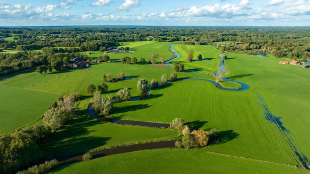 aerial view of a beautiful green landscape with a small river flowing through. It is in the eastern part of the Netherlands