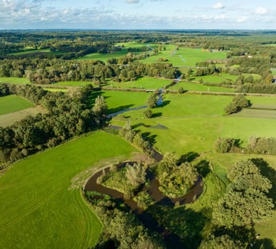 aerial view of a beautiful green landscape with a small river flowing through. It is in the eastern part of the Netherlands