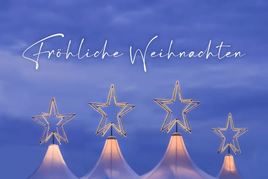 Wonderful x-mas season scene for visual or greetings card. Beautiful market tents with magic orange stars and blue sky at evening time.